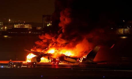 Japan earthquake relief: Five coastguard members missing and passengers evacuated after planes collide at Tokyo airport – latest updates