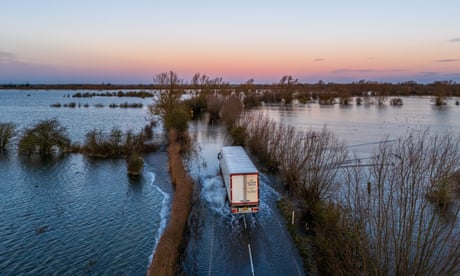 UK weather: disruption across road and rail network in England and Wales with hundreds of flood warnings in place – live